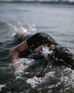 woman half submerge on body of water
