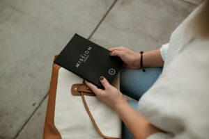 Purpose - woman holding black Mission book