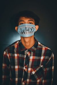 man in brown and black plaid button up shirt with face mask