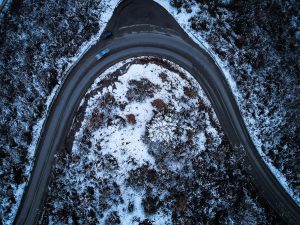 an aerial view of a road in the snow