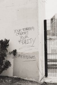 a black and white photo of graffiti on a wall