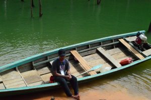 A man sitting in a boat on the water