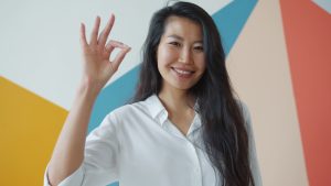 Woman making an ok sign with her hand.